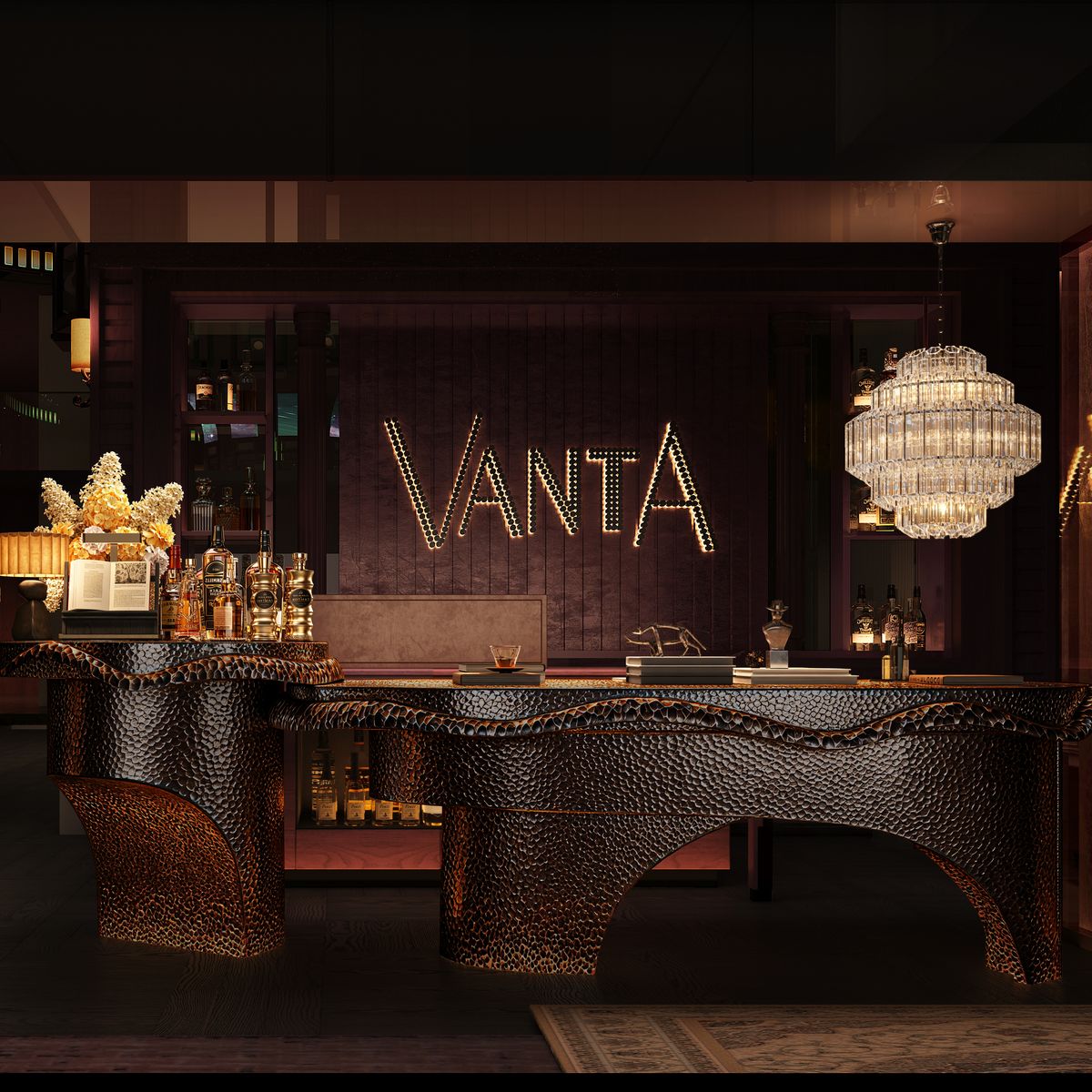The arrival at VANTA, a sculpted reception desk beneath a crystal chandelier and the VANTA name