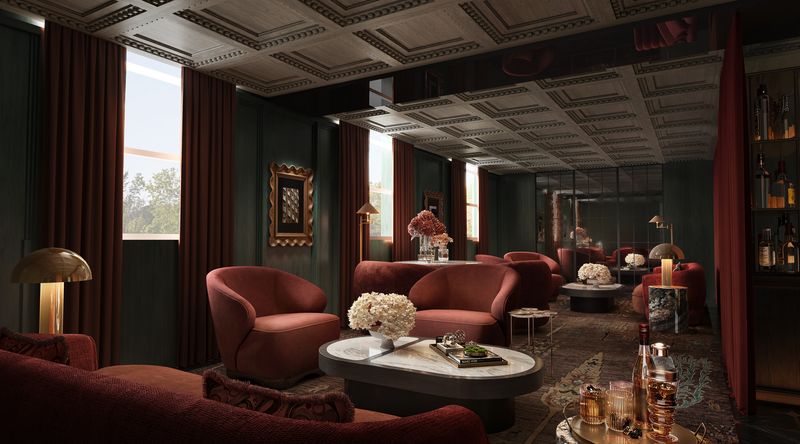 The arrival lounge at VANTA, red velvet armchairs beside tall windows