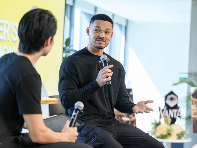 A speaker in conversation on stage at a VANTA fireside chat