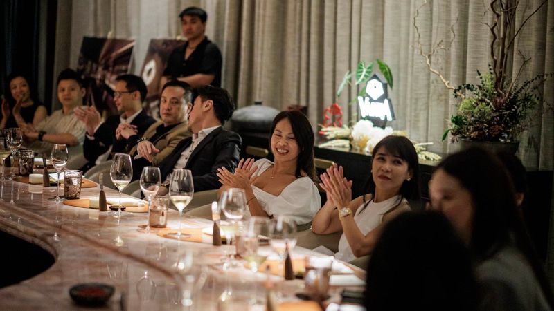 Guests applauding at a VANTA chef's table dinner