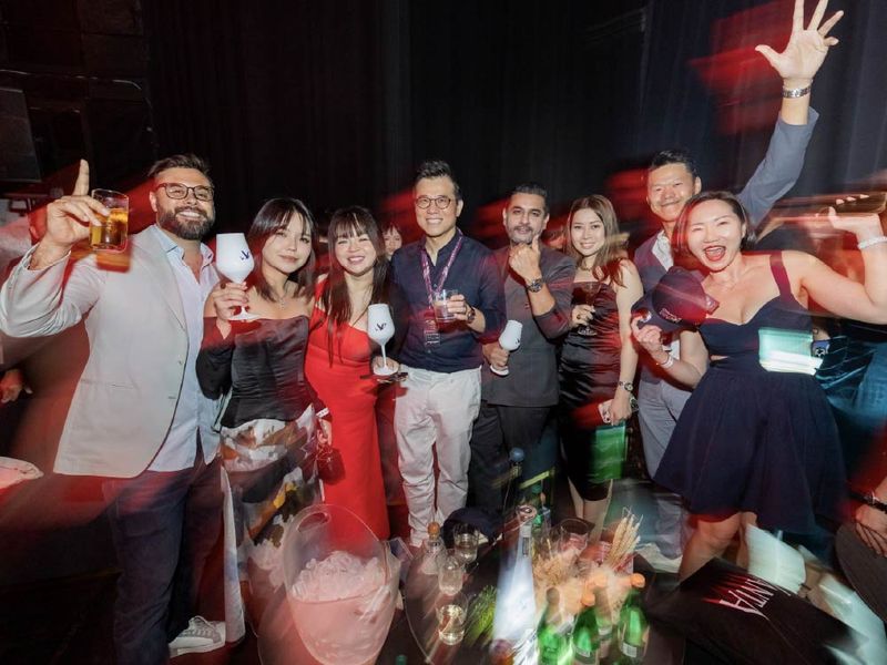 Members raising their glasses and cheering together at a VANTA party