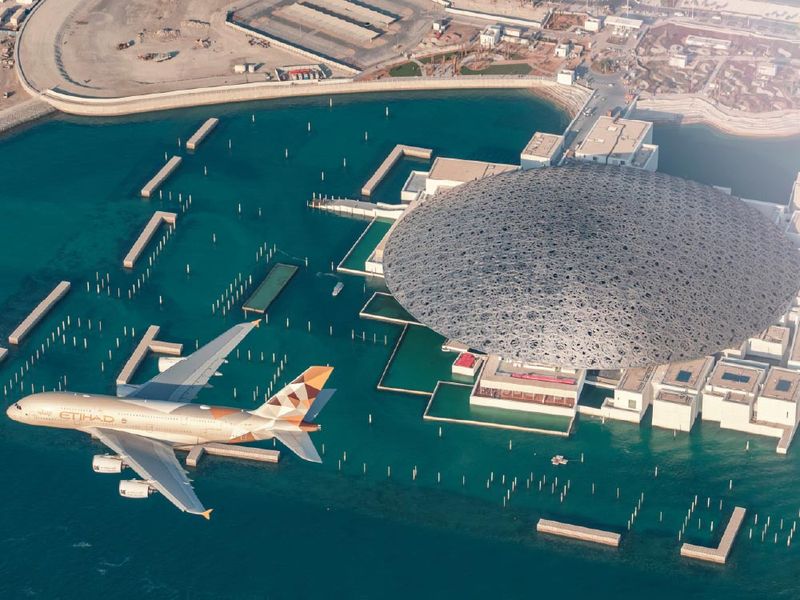 An Etihad Airways aircraft flying over Abu Dhabi, one of the VANTA travel partners